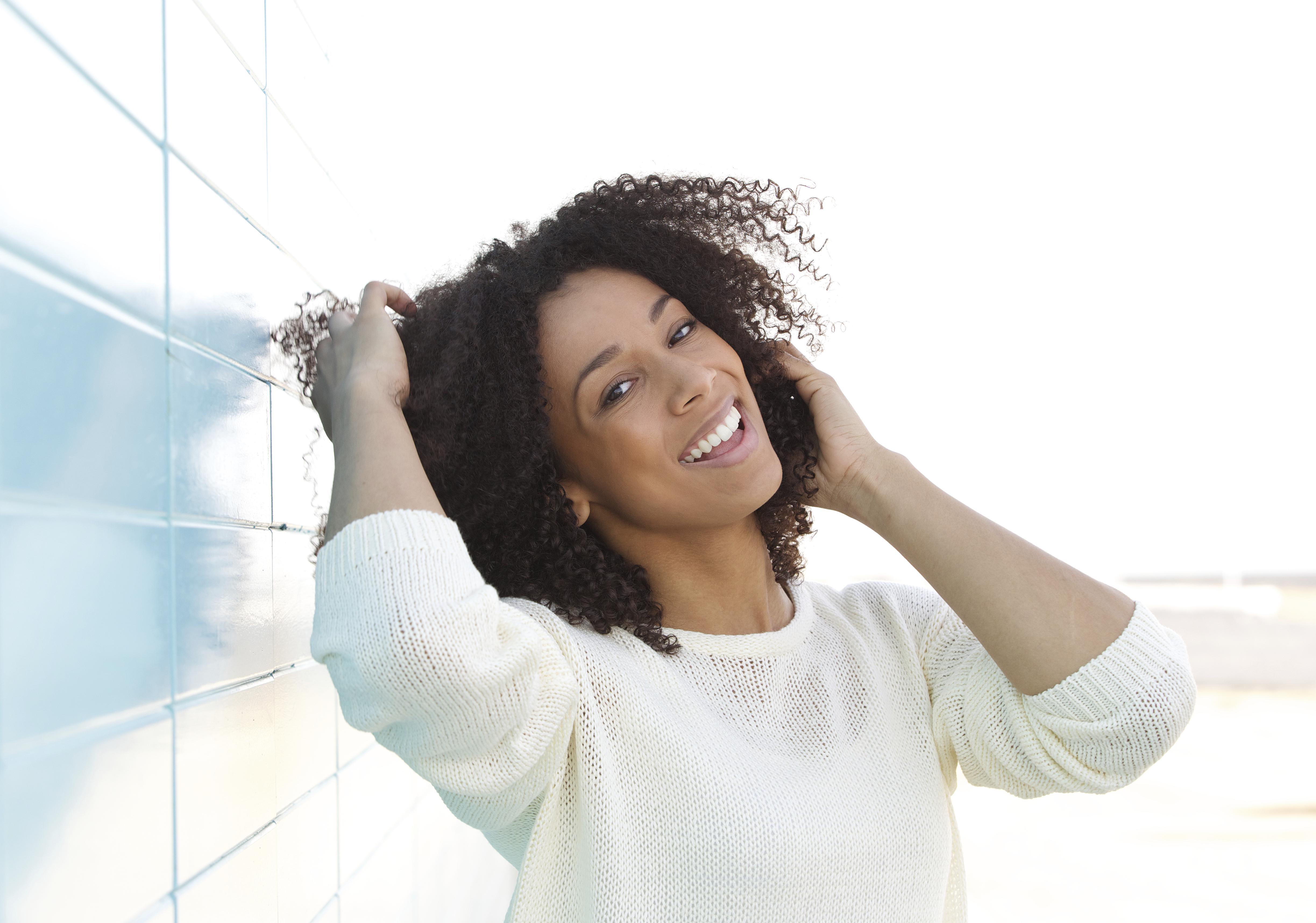 Close up portrait of an attractive young woman smiling outdoors