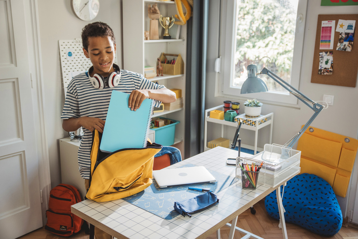 Teenage boy packing for school