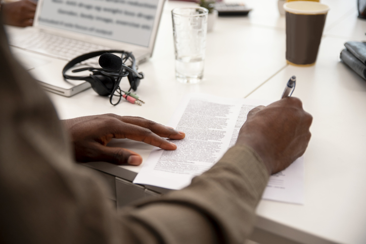 Business Man in office is filling out a document agreement or contract