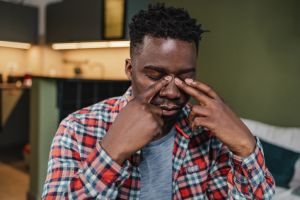 Young guy has a stressful day and headache